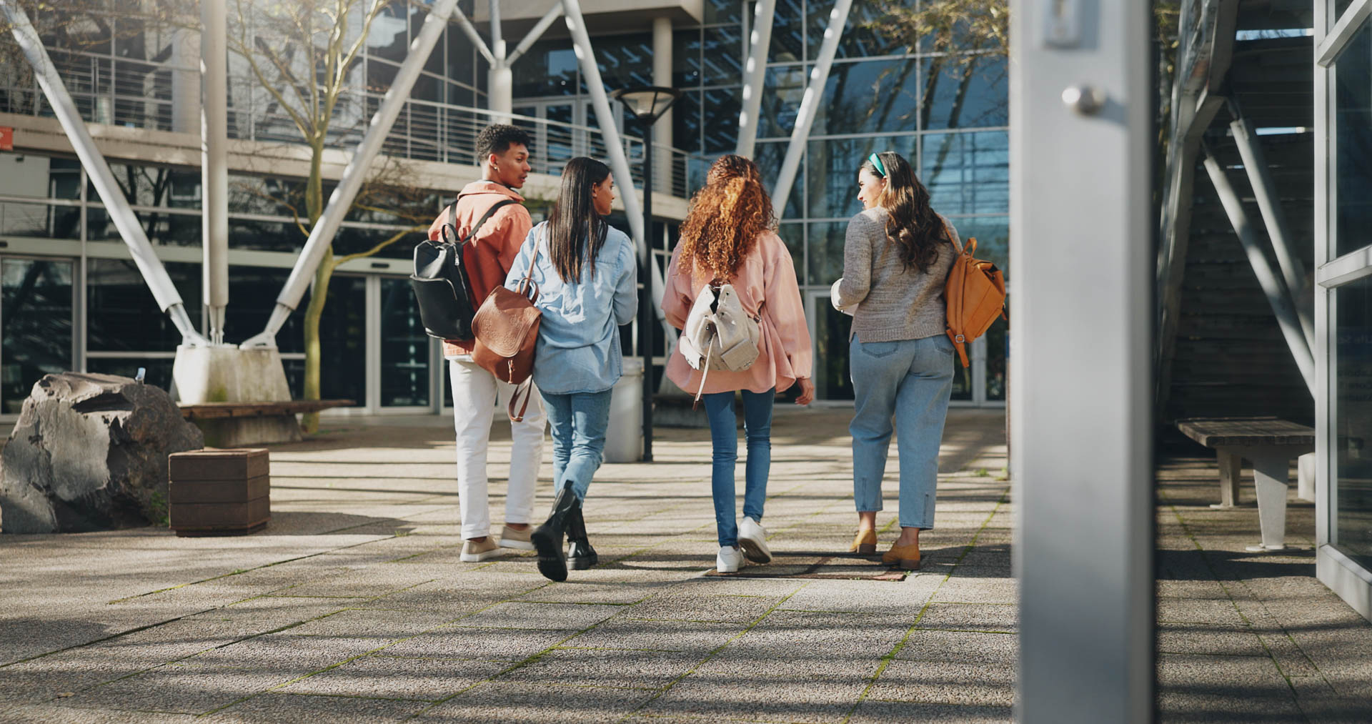 Group of students walking through a campus